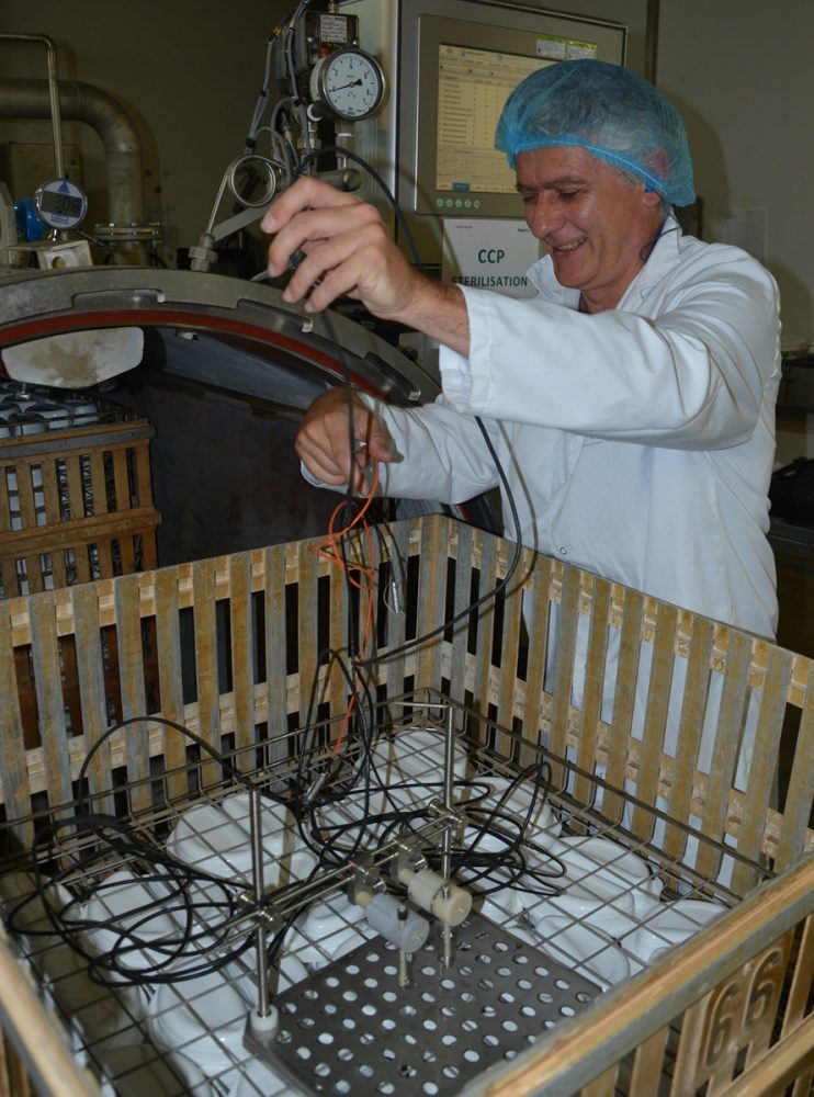 Alain Fournial, expert conserve, instrumente un panier d'autoclave pour mesurer la déformation de barquettes plastiques pendant leur stérilisation en autoclave